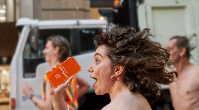 woman in profile running down street with mobile phone in hand that has the amaysim app on it